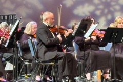 The violin section playing during the 2025 Holiday Concert
