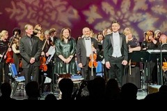 The conductor and special guests standing on stage after the 2025 Holiday Concert